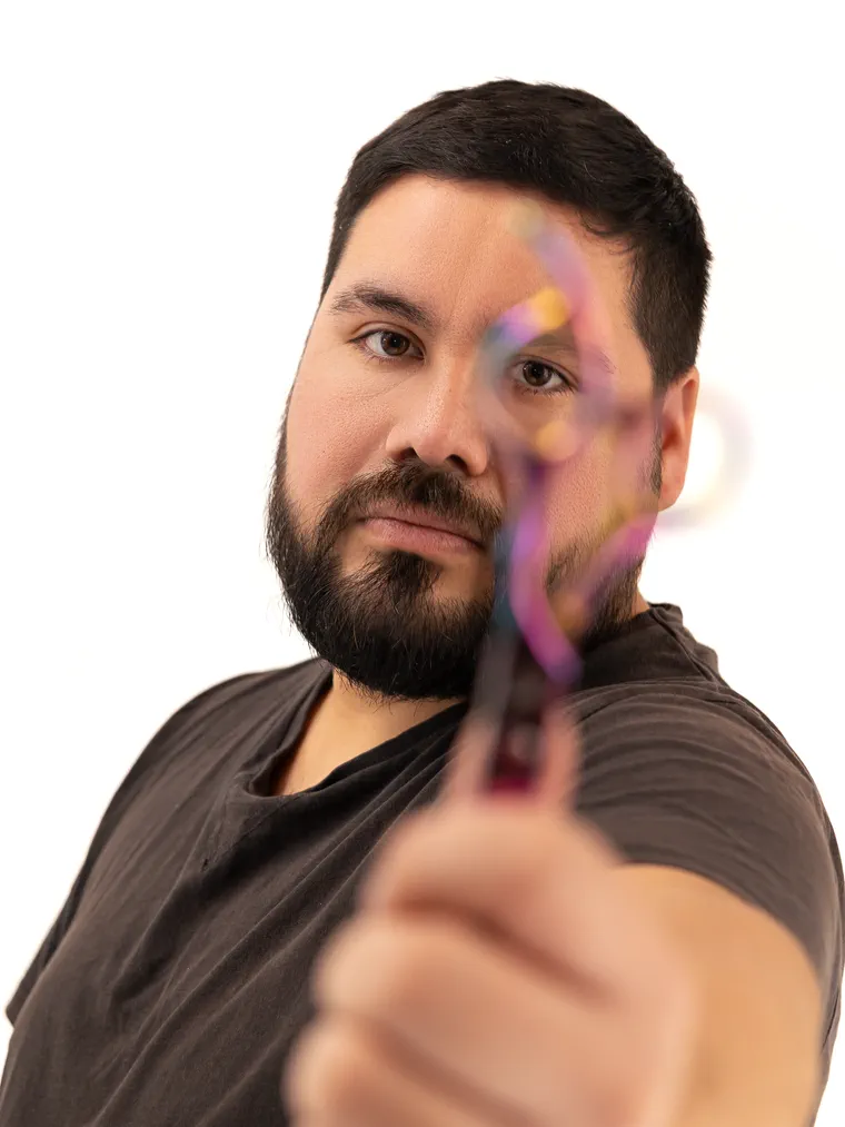El barbero muestra una navaja en primer plano, en el estudio